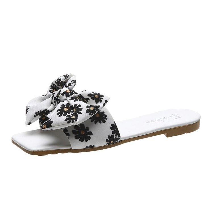 Dame fashionable slippers med legende blomsterdesign og elegante sløjfer Stilla