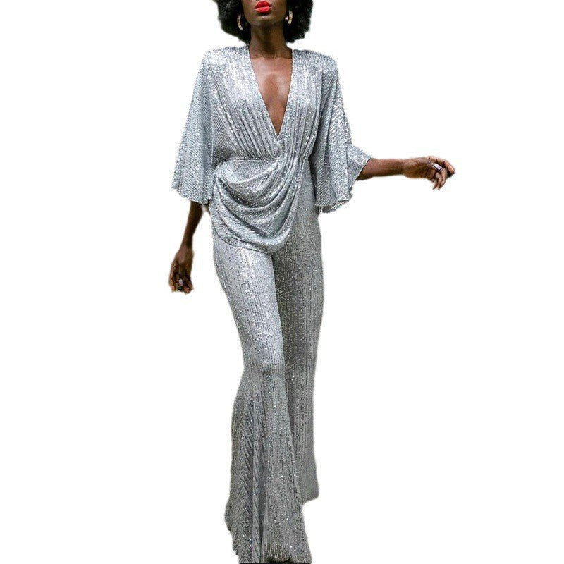 Dame glamourøs jumpsuit med glitrende paletter og vidde ben Stilla