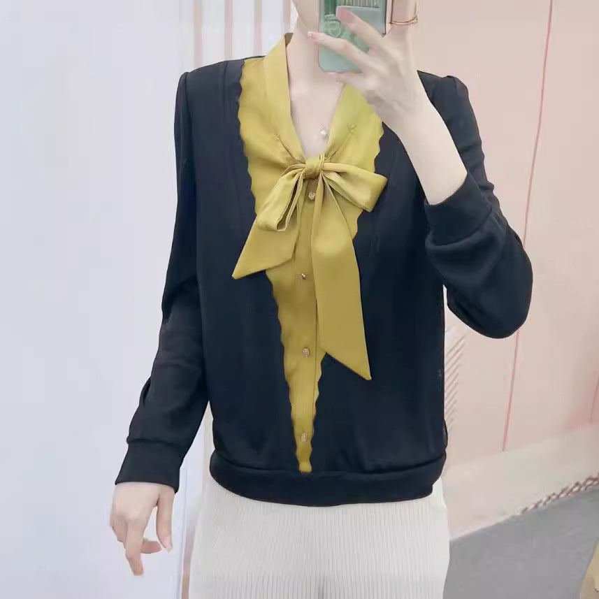 Damebluse med dekorativt sløjfekrave og elegante knapdetaljer Stilla