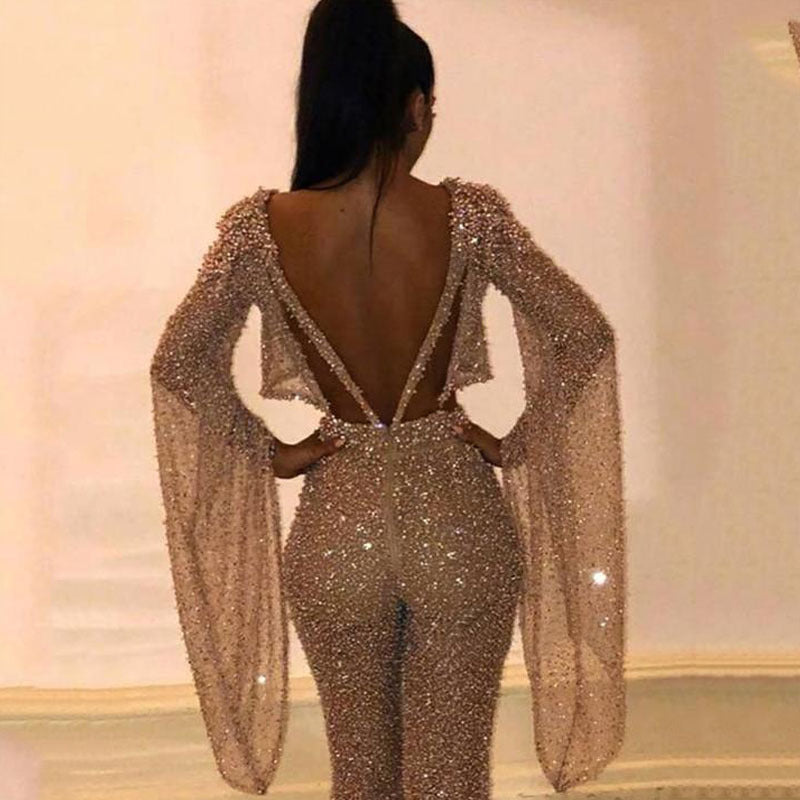 Dame Glitrende Jumpsuit med dyb ryg og flydende ærmer Stilla