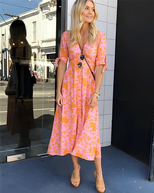 Stilla | Elegant kjole med et strålende orange print