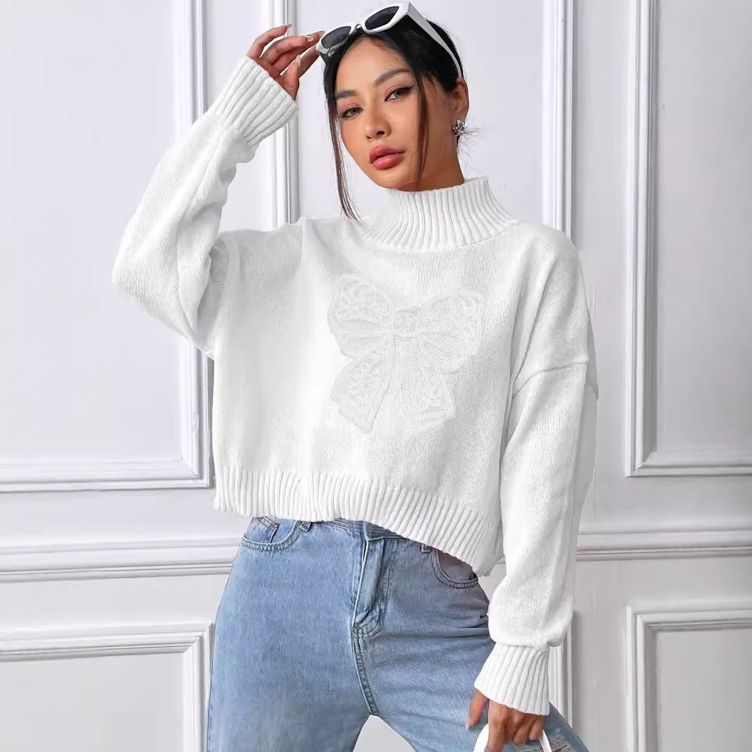 Dame afslappet rullekrave striktrøje med dekorativt sløjfemotiv Stilla