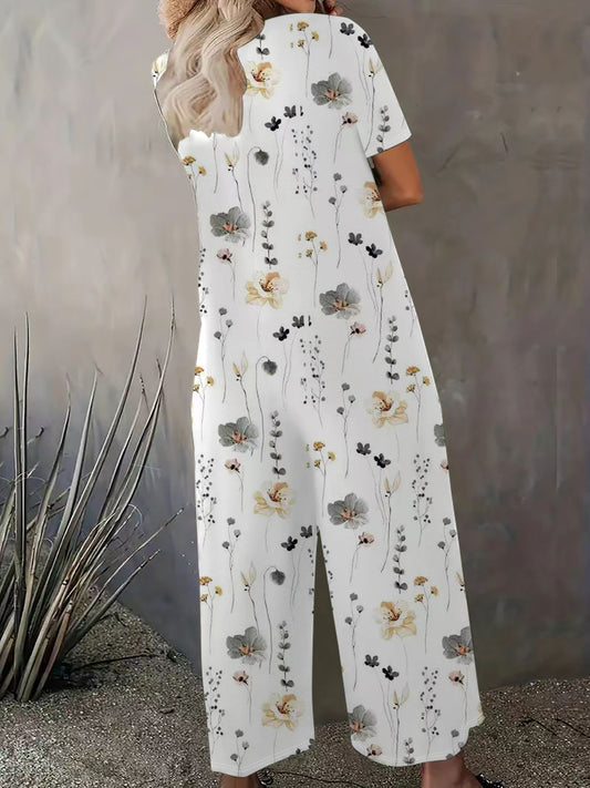 Damer bred blomster-jumpsuit med lommer og bådudskæring Stilla
