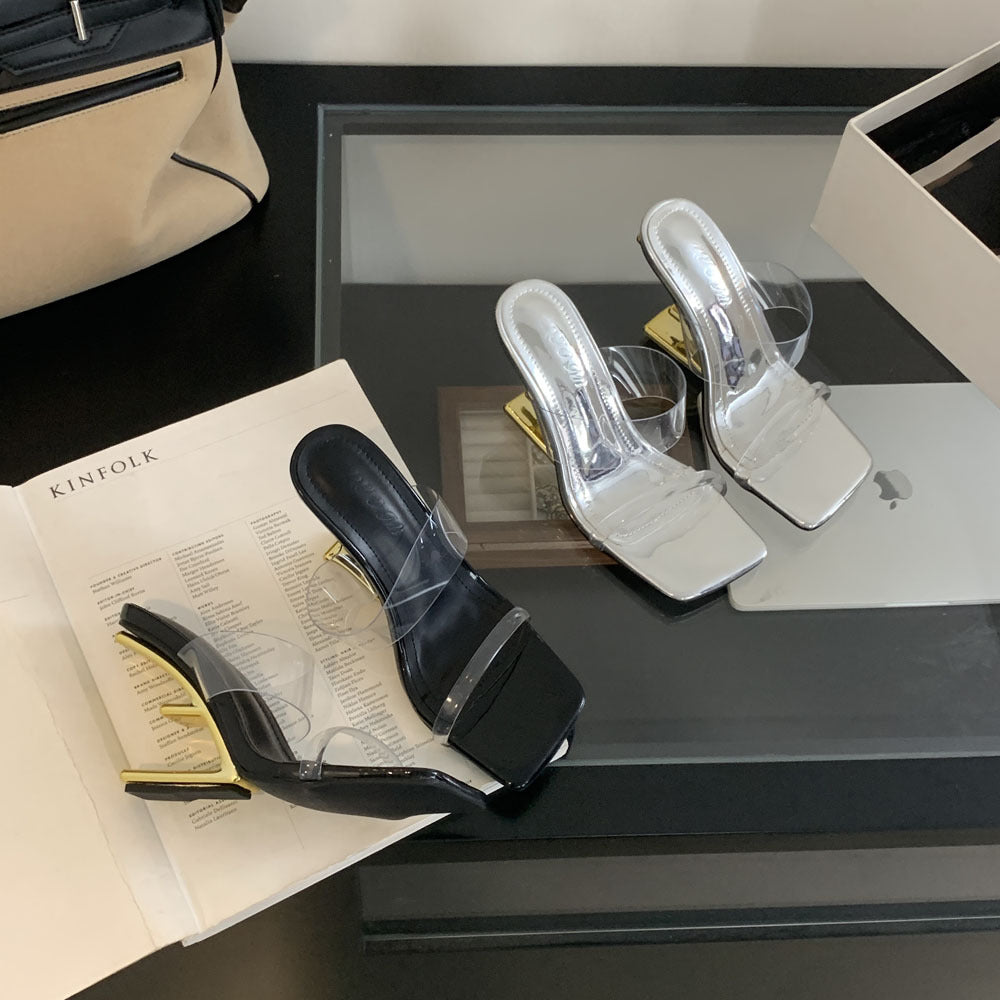 Dame åbne højhælede mules med transparent overmateriale og elegant metallisk accent Stilla
