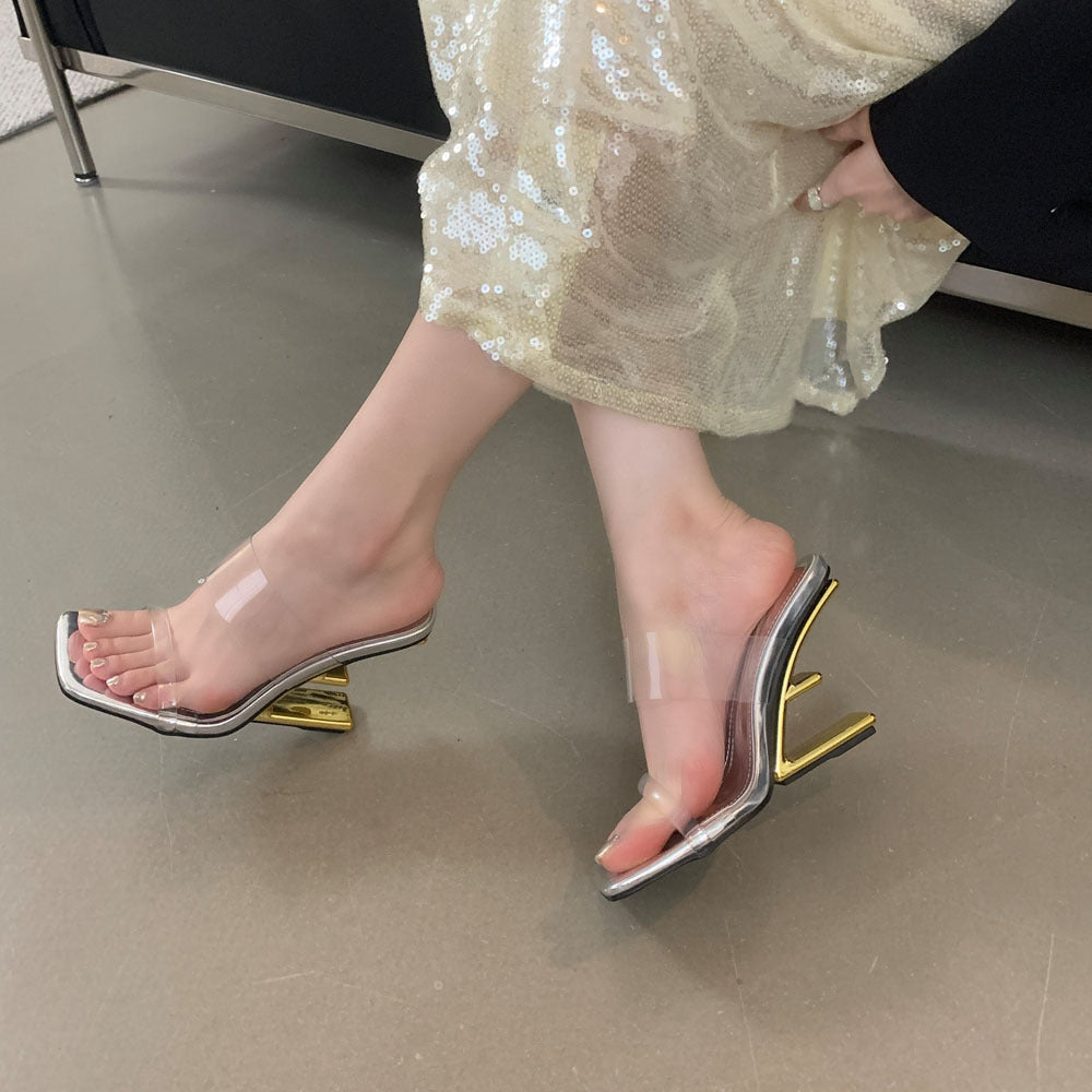 Dame åbne højhælede mules med transparent overmateriale og elegant metallisk accent Stilla