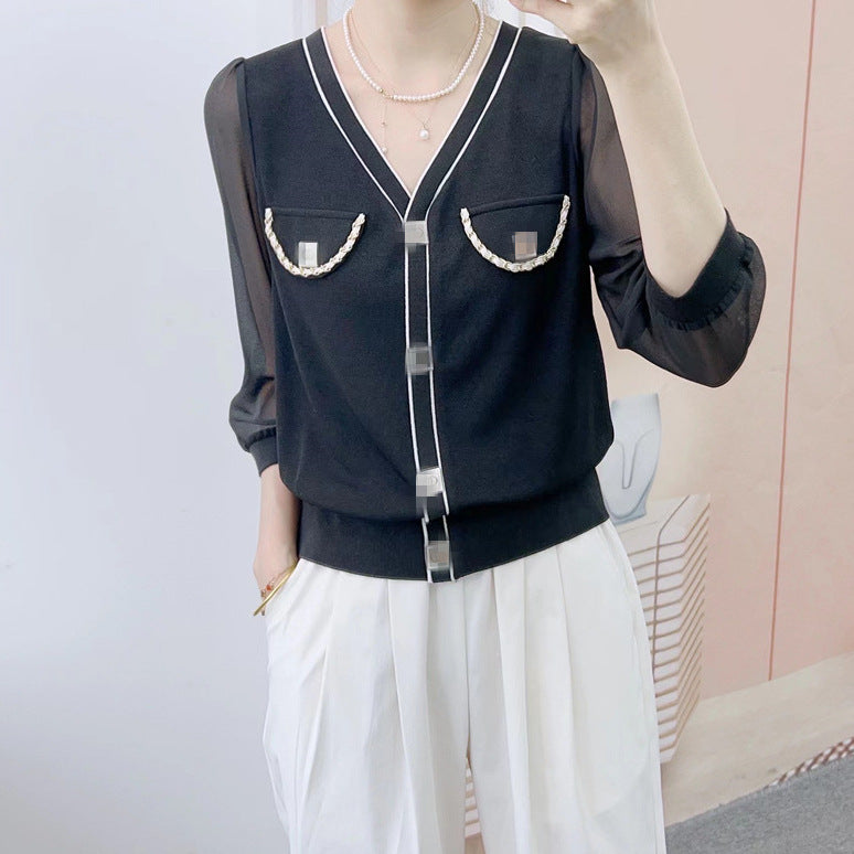 Dame elegant bluse med transparente ærmer og dekorative knapdetaljer Stilla