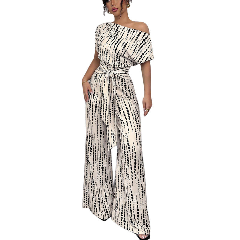 Dame elegant og luftig jumpsuit med asymmetrisk snit og bindebælte Stilla