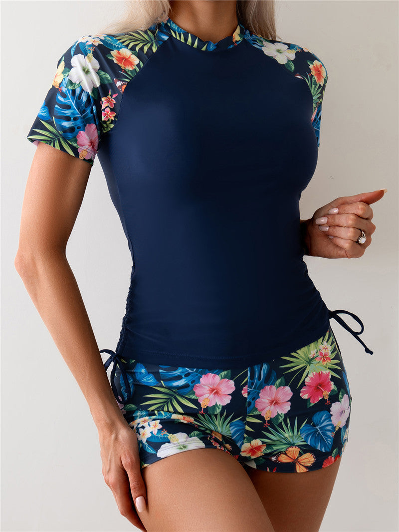 Dame Sporty Rashguard-sæt med blomsterdetaljer og elastiske shorts Stilla