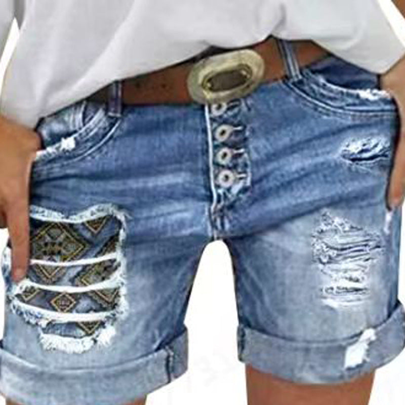 Dame denim-shorts med moderne ripped-design og farverige indlæg Stilla