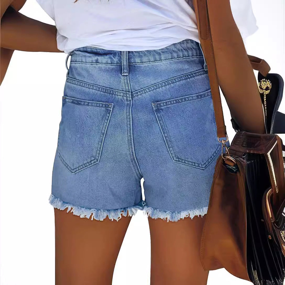 Dame afslappede Denim-shorts med moderigtige ripped-detaljer og Amerika-flags-elementer Stilla