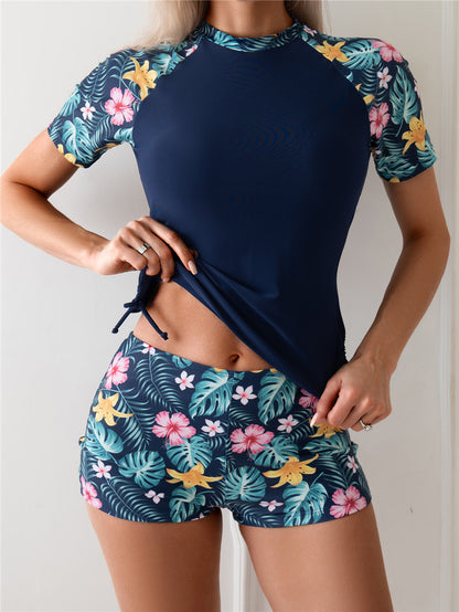 Dame Sporty Rashguard-sæt med blomsterdetaljer og elastiske shorts Stilla
