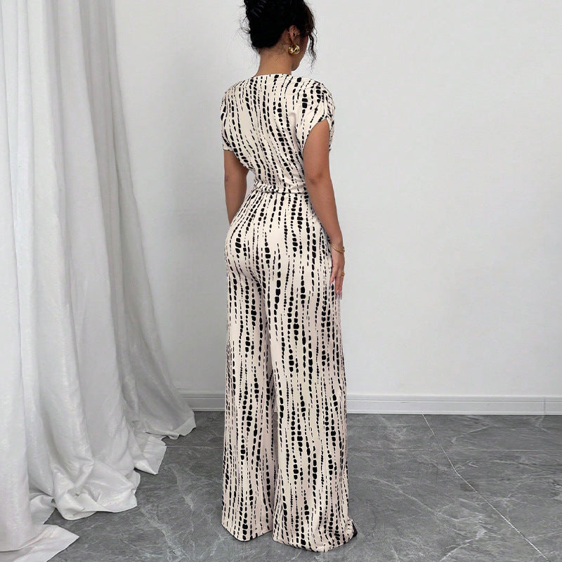 Dame elegant og luftig jumpsuit med asymmetrisk snit og bindebælte Stilla
